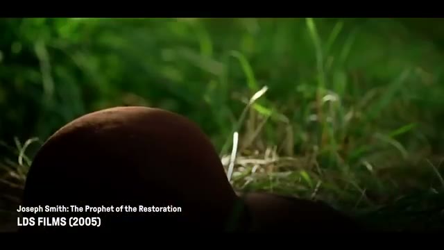 A still from a Church-produced video depicting young Joseph Smith kneeling in a grove of trees, praying.